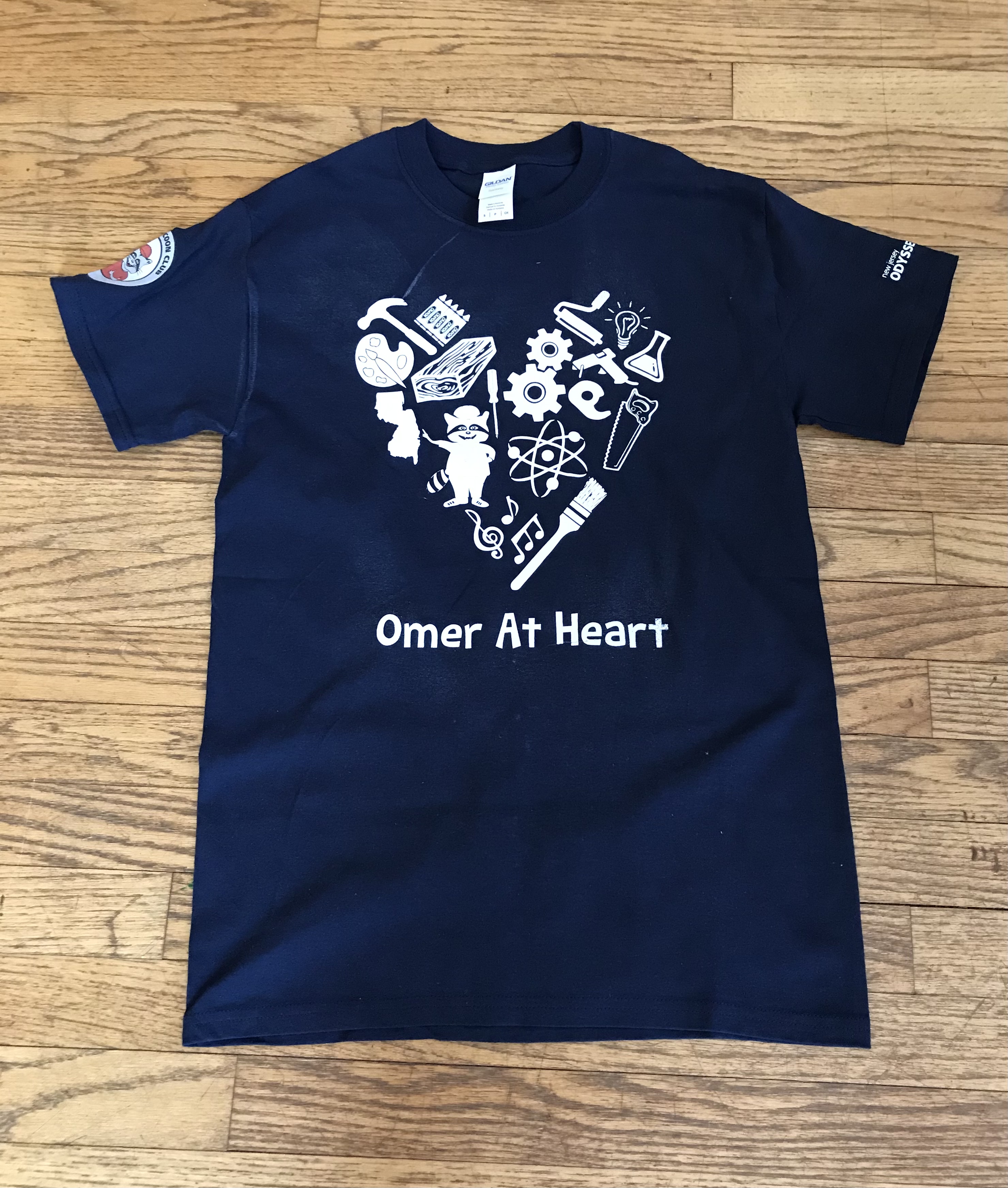 blue t-shirt with heart made from tools and other items that says "Omer at Heart"