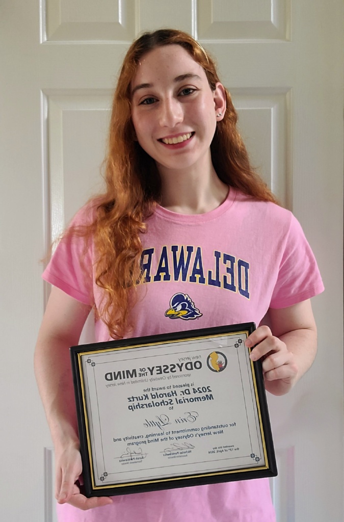 Student Erin Lyttle holding her award scholarship.