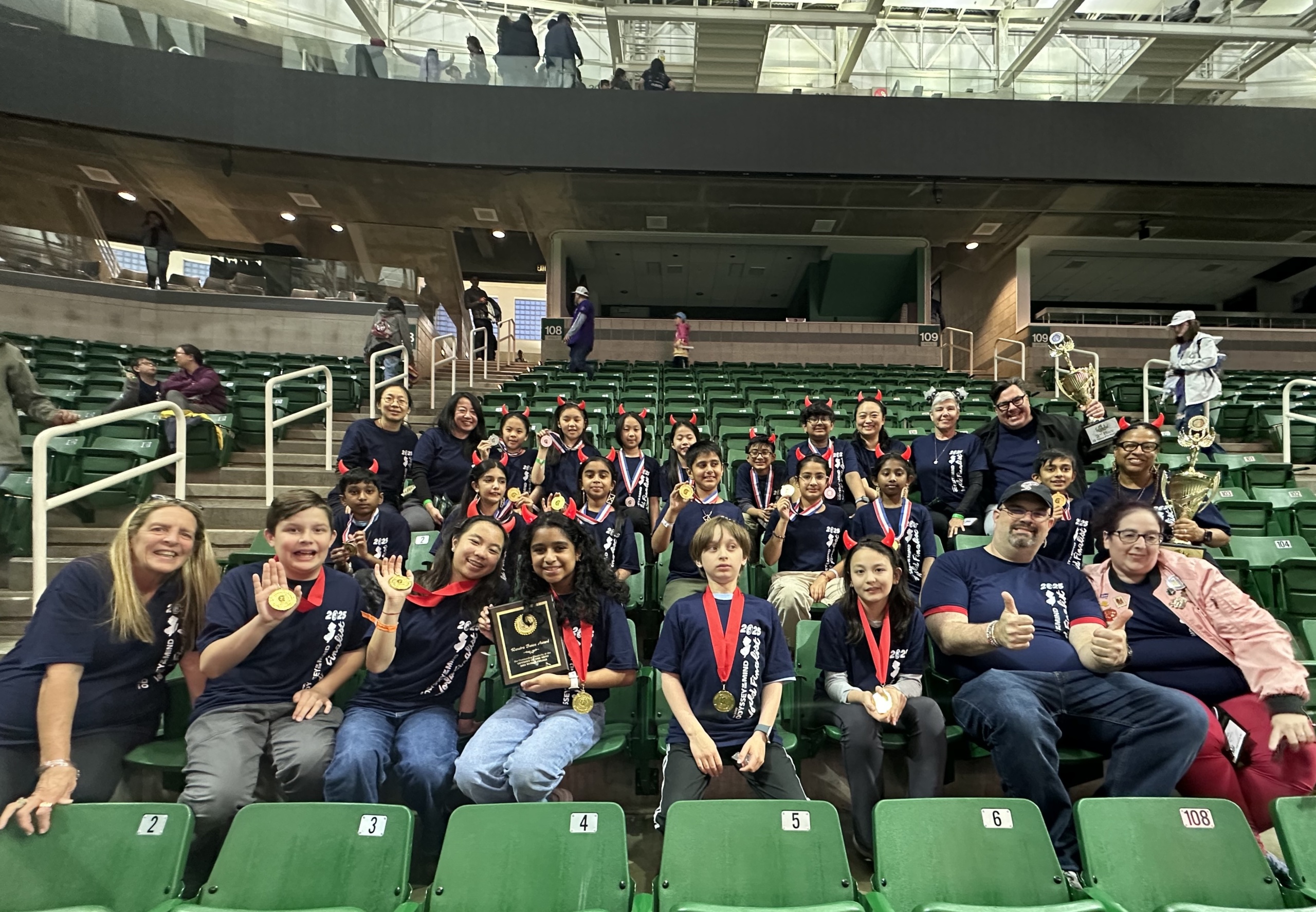 2025 NJ World Finals teams sitting in a stadium with bright green seats.