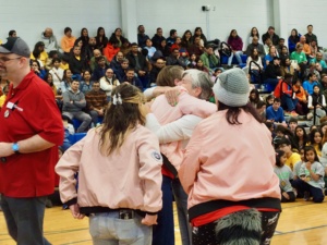 Joy, Ariana, and Sarah hugging Kate Naso.